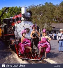 Three Calico Saloon Girls Standing In Front Of The Steam Train In The Ghost Town At Knotts Berry Farm California Saloon Girls Knotts Berry Farm Knotts Berry