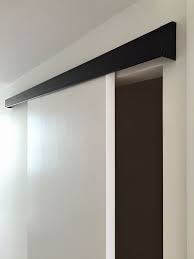 Black And White Barn Door Cavity Sliders Black Wall Mount Track With White Solid Core Sliding Door Exterior Sliding Barn Doors Black Walls Sliding Door Hardware