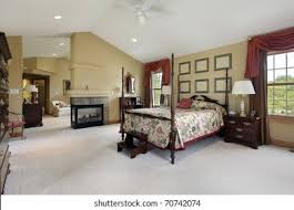 Interior design of master bedroom with exit to backyard sitting area with fireplace and armchairs. Master Bedroom Fireplace Sitting Room Stock Photo Edit Now 70742074