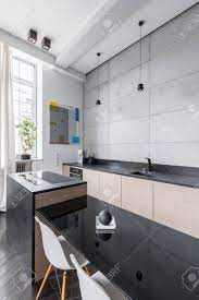 I've been thinking a lot about black kitchen countertops lately. Modern Kitchen With Black Countertops Table And White Chair Stock Photo Picture And Royalty Free Image Image 69572000