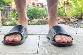 Bare Feet Of Boy In Black Slippers With Hairy Legs In Your Back Yard  Фотография, картинки, изображения и сток-фотография без роялти. Image  42420526