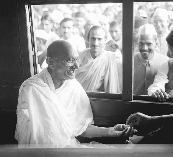 Mahatma Gandhi receives a donation in a train compartment — PICRYL - Public Domain Media Search Engine