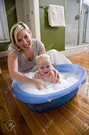 Maybe you want to save water by sticking to a small baby bath. Happy Mother Bathing Her Cute 7 Month Old Baby Stock Photo Picture And Royalty Free Image Image 6610668