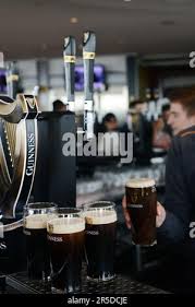 Enjoying a pint of Guinness Stout at the rooftop bar at the Guinness  Storehouse at St. James's Gate in Dublin, Ireland Stock Photo