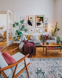 The plush sofa makes things extra inviting. Abstract Art Gallery Wall At The Ozy Boho Living Room Boho Living Room Boho Living Room Decor Gallery Wall Living Room