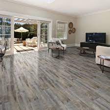 Double aspect living room painted in farrow & ball cornforth white, with a large grey rug layered with a cowhide (both from the rug seller). World Of Flooring Excellence Plank Tavern Grey Rustic Living Room Baltimore By Carpet Wood Floor Liquidators Houzz