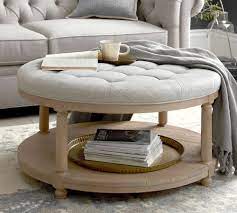 Made from solid wood, it has a rounded silhouette for an understated, streamlined look that's perfect for breaking up the monotony of straight lines. Berlin Round Ottoman Pottery Barn