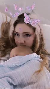 Grimes lovingly cradles newborn baby X Æ A-12 in new video... nine days  after birth