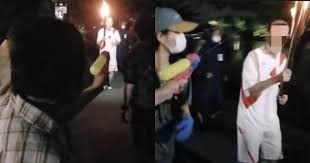 Shortly before the event began, malaysian police ushered a japanese family away from the starting point. This Woman Tried Putting Out The Olympic Torch With A Water Gun Culture