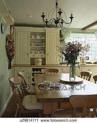 Save on pine dining room furniture. Metal Chandelier Above Pine Dining Table And Chairs In Traditional Country Kitchen Stock Image U29814171 Fotosearch