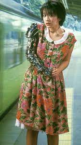 jun togawa, dressed up with a robotic arm