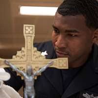 Religious Programs Specialist Erik Pautsch, assigned to the amphibious  assault ship USS Bonhomme Richard (LHD 6), picks weeds during a volunteer  service project at Kain-so Nursing Home.