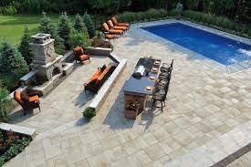 We can provide you with gorgeous concrete pavers that are stronger and less porous than brick, which is more likely to crack, chip, and wear down as years go by. Outdoor Living Patio And Pool With Umbriano Paver Patio Pool Patio Outdoor Living Patios