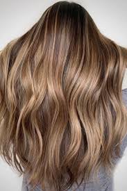 Brown hair with blonde highlights. These Dark Blonde Color Ideas Are Low Maintenance Goals Dark Blonde Hair Color Blonde Hair With Roots Dark Roots Blonde Hair
