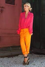 Hot Pink Long Sleeve Shirt With Cuffs Up Open Convertible Collar Neon Gold Skinny Pants With Rolled Cuffs Black And Tan Espadrill Style Fashion Chic Outfits