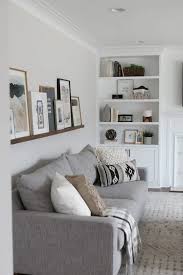 Diy gallery wall | how to style a photo ledge shelf. Diy Picture Ledge Over The Couch Filled With Art The Diy Playbook