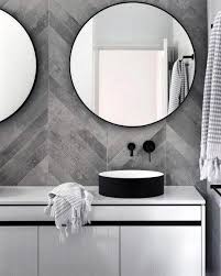 Gorgeous bathroom features a tub nook with barrel ceiling lined with honed calacata herringbone tiles, walker zanger tangent chevron, filled with a modern freestanding tub and floor mount tub filler placed in front of windows dressed in peacock blue curtains layered over taupe roman shades alongside an ash gray and honed calacata tiled floor, walker zanger astral night. Top 60 Best Grey Bathroom Tile Ideas Neutral Interior Designs Grey Bathroom Tiles House Bathroom Bathroom Design