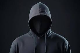 A mysterious figure in a black hoodie stands against a dark backdrop,  creating an enigmatic atmosphere of suspense and intrigue 55153735 Stock  Photo at Vecteezy