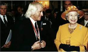 On the one hand jimmy was the flamboyant pop presenter who appeared regularly on tv. Jimmy Savile With The Queen Pretty Hats Ted Heath Black Books