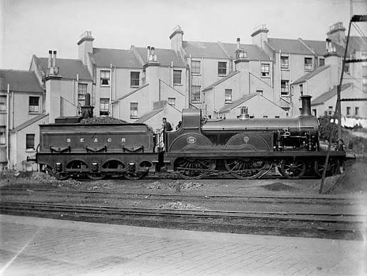 Stirling loco against the rear of Braybrooke Road. This is a view that has not changed much! This loco is depicted in the Illustrated London News picture we have used for our