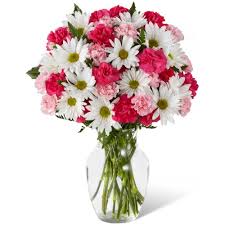 Pink lilies make the eyes dance across the unique design of this flower bouquet, surrounded by the blushing colors of orange roses, lavender cushion poms, hot pink carnations, and lush greens. Sweet Surprises Bouquet Ftd Flowers Toronto Ital Florist