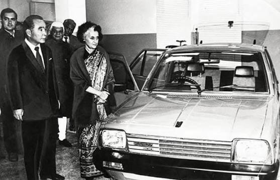 Prime Minister Indira Gandhi, with Rajiv Gandhi and ND Tiwari in the background, inspects a model car before inaugurating the Maruti factory in Delhi on December 14, 1983... ✨ 📸 by The Hindu