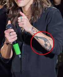 Harry styles wears his tattoos well. Harry Styles Tattoos Guide To His Ink And Their Meanings