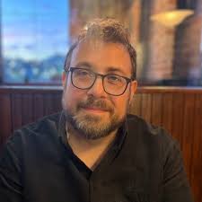 I am a little confused why Bon Iver was wearing a big mask while recording  alone in his home studio while Swift and the others were states away in the  Folklore special -