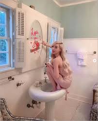 tiffany poses atop a bathroom sink