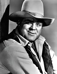 Dan Blocker, famously known as Hoss, stood grinning but a bit bashful,  sandwiched between three lovely women. On his left was Lily, and