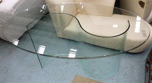 They give a definite end to the table with is pretty useful if you have a patriarch that insists on sitting at the head, but you want to keep a more casual feel in your home. Dining Table With An Oval Glass Top On An S Shaped Glass Base 160cm X 100cm X 76cm H As Found