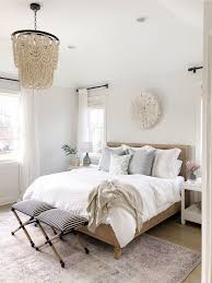 Neutral Bedroom Features Beaded Chandelier Vintage Inspired Rug White Bedding And Tassel Pil Neutral Bedroom Decor Master Bedrooms Decor White Master Bedroom