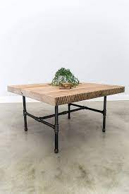 It features a black cast iron leg and a solid wooden plate with a black iron frame. Amazon Com Square Coffee Table Made Of Reclaimed Wood And Iron Pipe Legs Reclaimed Wood Coffee Table Industrial Table Custom Designs And Sizes Welcome Made From Salvaged Barn Wood Fast Free Shipping