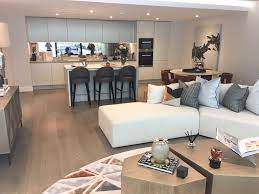 This Stylish Open Plan Living Room And Kitchen At The Dumont Feels Cozy Yet Seamlessly L Open Plan Kitchen Living Room Livingroom Layout Open Plan Living Room