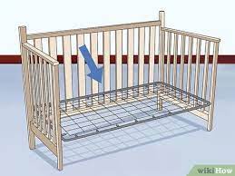 Place one of the remaining springs over the dowel and set it slightly above the lowest hole in the drop side rail. How To Set Up A Baby Crib With Pictures Wikihow