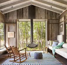A wall of windows make this sunroom a comfortable place to relax, while the white walls and ceiling maximize the warm illumination of the natural light. Timeless Allure 30 Cozy And Creative Rustic Sunrooms