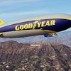 A few dozen goodyear workers were on hand as the blimp fluttered to the ground. 1