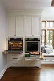 What materials (h depot has some aluminum mosaic panels) could i put on the wall to guard against heat from the oven and spash or fire from range? Side By Side Wall Ovens Transitional Kitchen