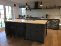 This is what it looked like when we got the drywall down Stunning Blue Kitchen With Island And Built In Breakfast Bar Modern Kitchen Surrey By Handmade Kitchens Of Christchurch Houzz Uk