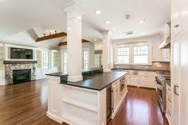 A portion of this modern kitchen area has a dropped ceiling, and the post and beams appear as two posts work well for a wide island, and the symmetry looks pleasing and purposeful. Kitchen Islands With Columns Designing Idea