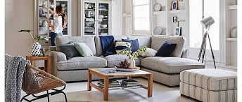 There is a big sofa in the room and a little lamp on the wall over the sofa. Will It Fit Living Room Furniture M S