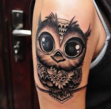 This beautiful tattoo shows a black and gray boat anchor covered in pink and blue flowers done in a minimalist, watercolor style. Beautiful Owl Tattoo Design 1 Kickass Things