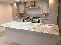 In a colonial white kitchen like this one, a grey countertop is the finest option. Home Products Granite Colonial White