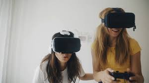 Beautiful companions who love to play. Two Women In Modern Virtual Reality Headsets Playing Video Games And Having Fun Together Pretty Girls In Vr Helmets At Home 3d Technology Concept Of Virtual Reality Gaming Friendship Stock Video Footage