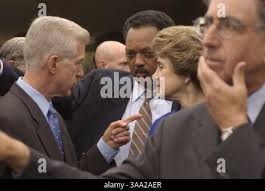 Rev. Jesse Jackson, right, speaks with reporters accompanied by Haitian  priest Gerard Jean Juste, supporter of former Haiti's President  Jean-Bertrand Aristide, after their meeting at the St. Claire church in  Port-au-Prince, Monday,
