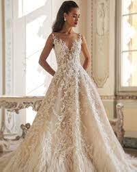 The Fleur Gown For The Couture Minded Bridelace Accents And Feather Edges For Major Statement Wedding Dress Suit Feather Wedding Gowns Demetrios Wedding Dress