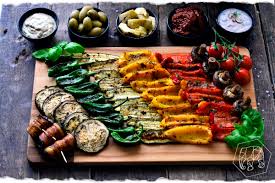 Typical ingredients of a traditional antipasto include cured meats, olives, peperoncini, mushrooms, anchovies, artichoke hearts, various cheeses (such as provolone or mozzarella), pickled meats, and vegetables in oil or vinegar. Italienische Antipasti Mediterranes Gemuse Discover Vegan