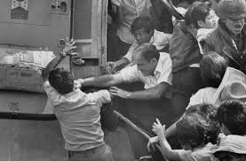 Navy personnel aboard the uss blue ridge push a helicopter into the sea off the coast of vietnam in order to make room for more evacuation flights from saigon, tuesday, april 29, 1975. American Official Punches A Vietnamese Man During The Evacuation Of Saigon 1975 Piqueshow