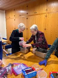 Sisters Lucy Miller, Dorothy Manuel, Judy Huber, Katherine Kraft, Katherine  Howard, Pat Ruether, Lucinda Mareck, and Laura Suhr joined Elizabeth Reum,  director of social justice ministries, to pack beans and rice, which