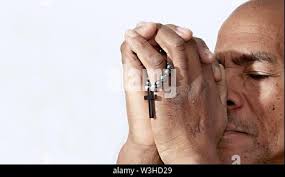 black man praying to god with cross and hands together Caribbean man  praying with white background stock image stock photo Stock Photo